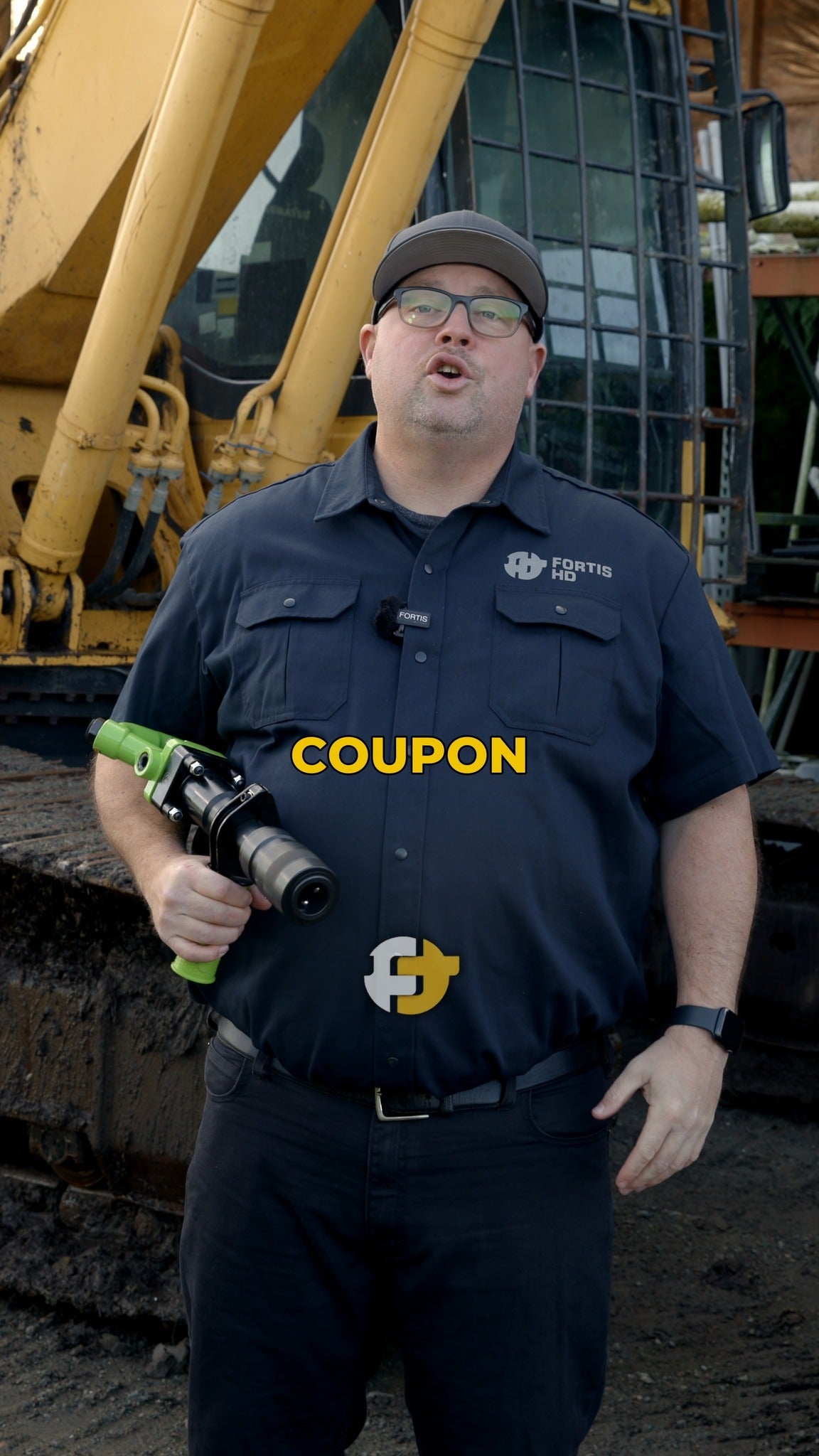 Operator demonstrating the Big Chooch air hammer in front of heavy construction equipment.