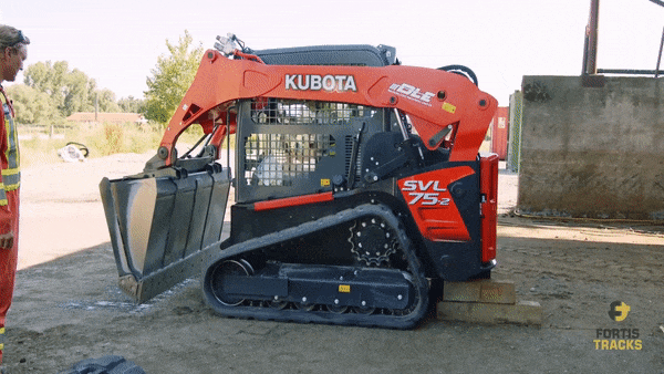the operator raises up the compact track loader using the Kubota bucket