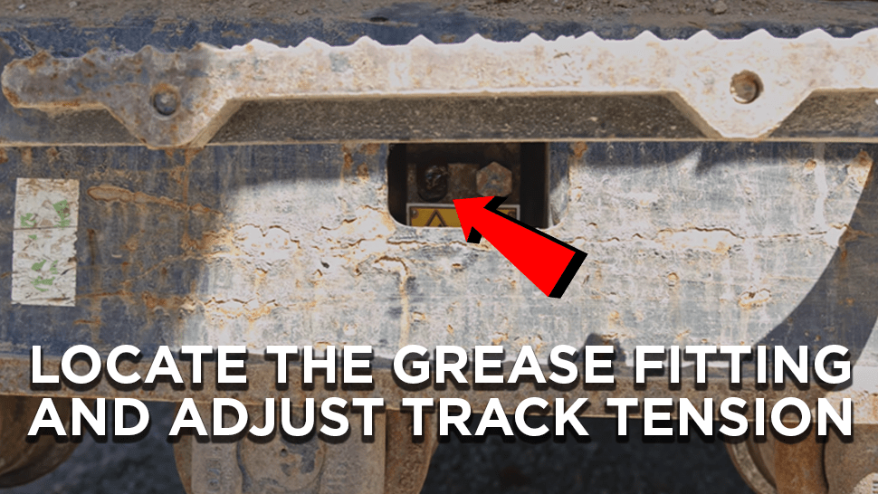 Arrow points to the location of the grease fitting on an excavator