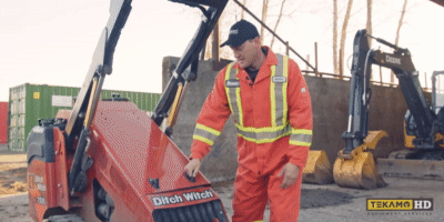 HD mechanic opens up the hood on a Ditch Witch mini skid steer