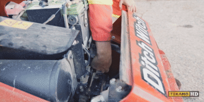 Pulling the old spin-on fuel filter out of a Ditch Witch mini skid steer