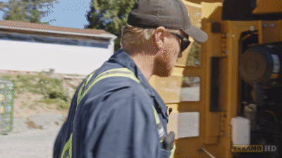 Heavy duty mechanic locates the air filter on a Caterpillar excavator