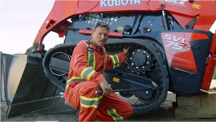 Heavy-duty mechanic changes the rubber tracks to a Kubota SVL 95 Skid Steer.