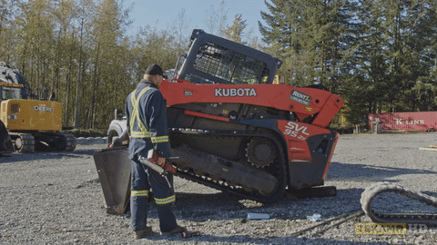 Operator drives forward and backward the rubber track on a Kubota SVL95 CTL.
