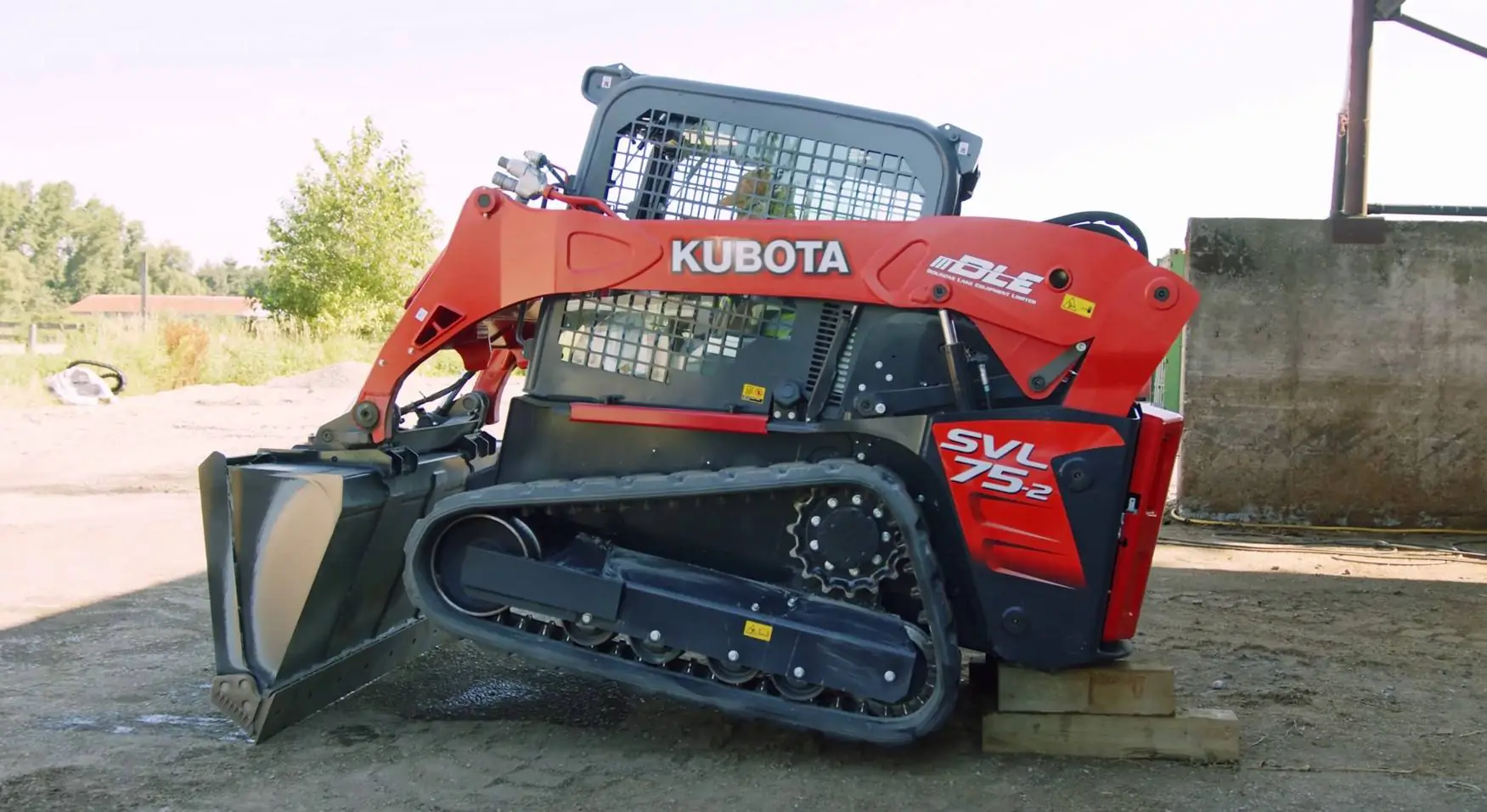 a Kubota SVL-75 lifted off its' tracks using the boom and bucket