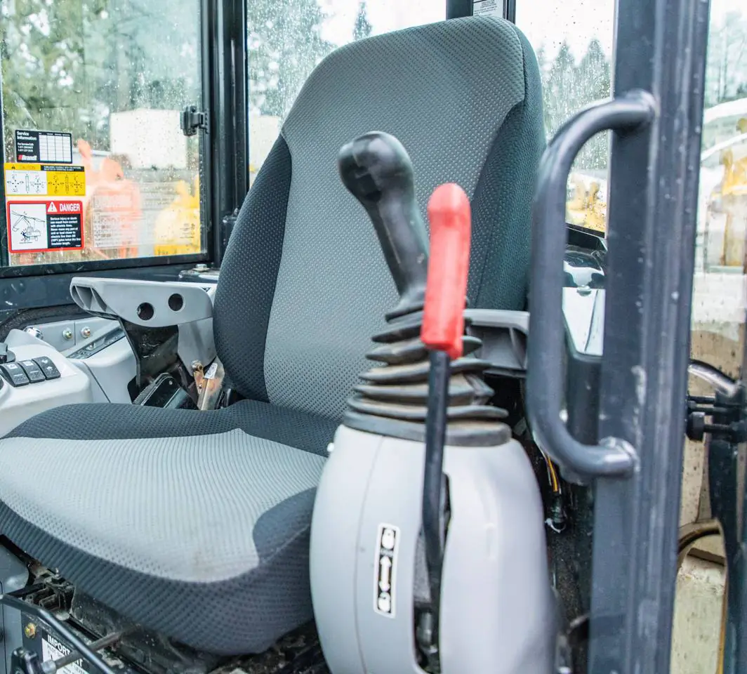 Safety lever on a John Deere 35G mini excavator