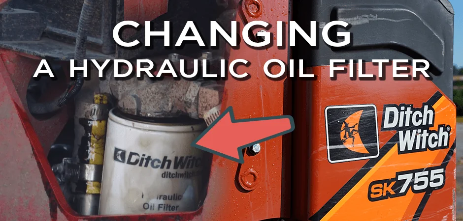 arrow pointing to the hydraulic oil filter inside a Ditch Witch mini skid steer