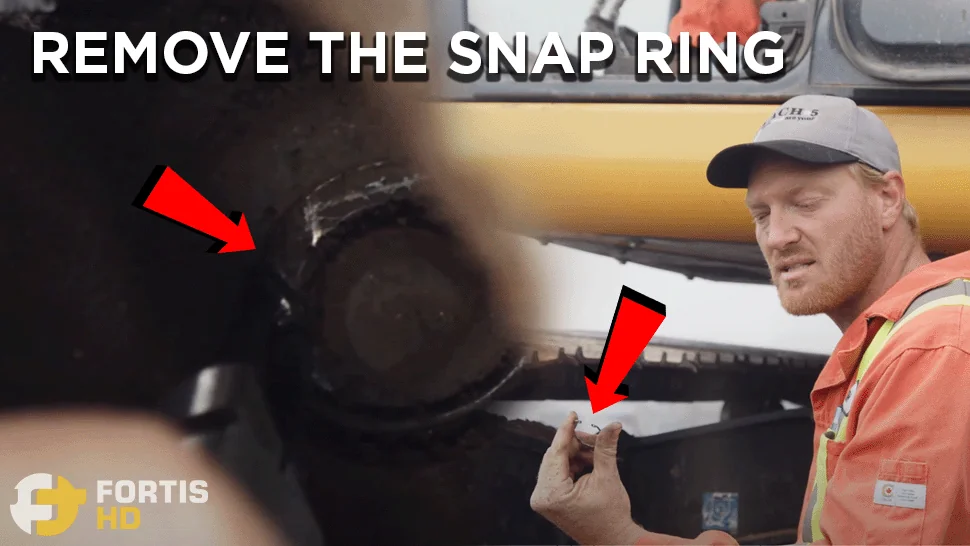 Heavy-duty mechanic holds a snap ring.