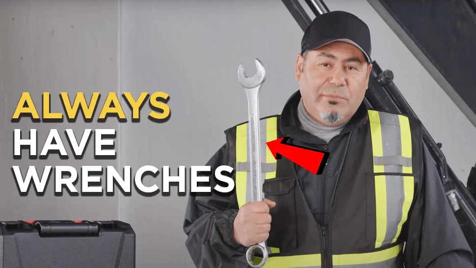 Heavy duty mechanic holding a wrench