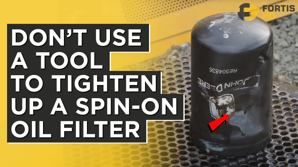 A crushed spin-on oil filter. The overlay arrow reads: Don’t use a tool to tighten a spin-on oil filter.