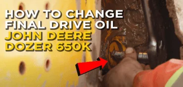 Pro HD mechanic removing check and fill plug, with a overlay text saying (HOW TO CHANGE FINAL DRIVE OIL JOHN DEERE DOZER 550K)