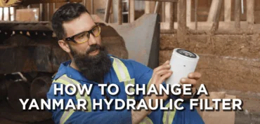 A mechanic is holding a hydraulic filter