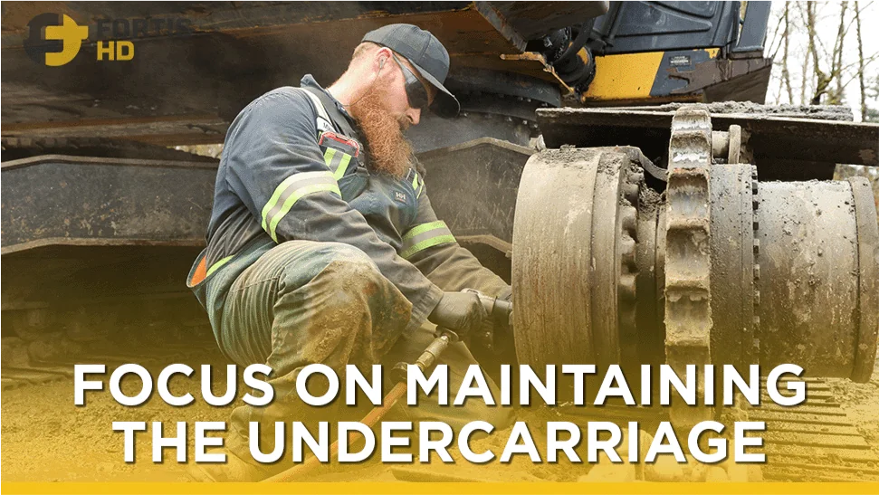 Heavy-duty mechanic servicing heavy equipment undercarriage. Overlay text reads: focus on maintaining the undercarriage.