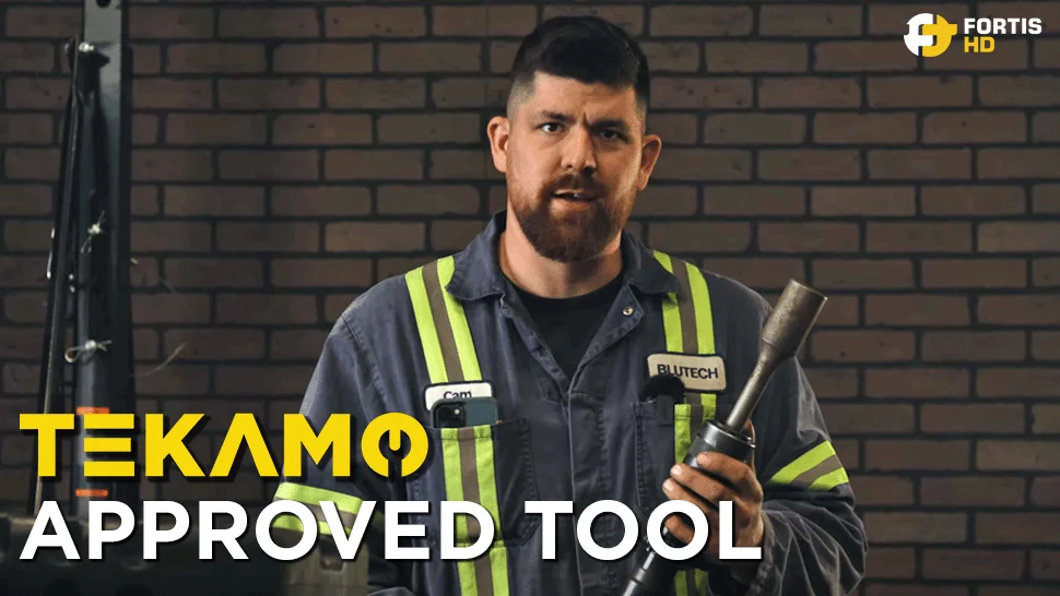 Heavy-duty mechanic holds a Vibro-Impact Air Hammer.