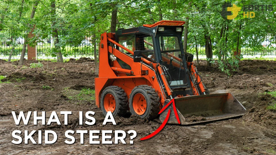 Skid steer in a forested worksite.