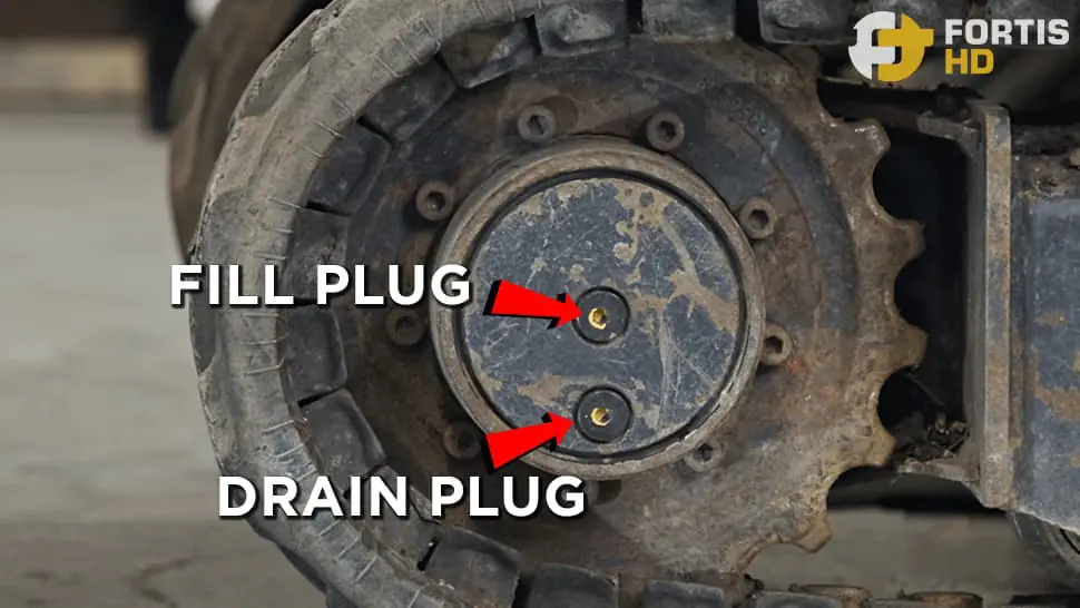 Arrows point at the fill and drain plugs of a John Deere 17G