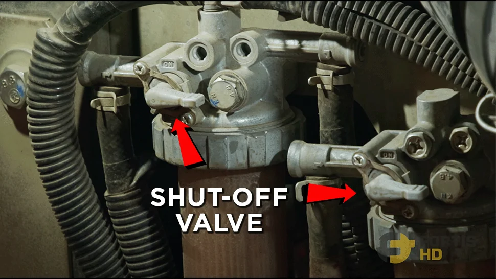 Arrows pointing at the fuel shut-off valves on a John Deere 17G Mini Excavator.