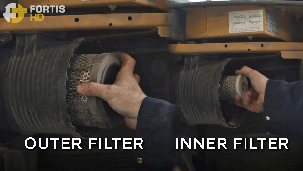 A heavy-duty mechanic removes the engine air filters on a John Deere 85G Excavator.