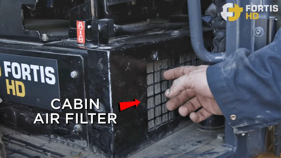 Arrow pointing at the location of the cabin air filter on a John Deere 85G Excavator.
