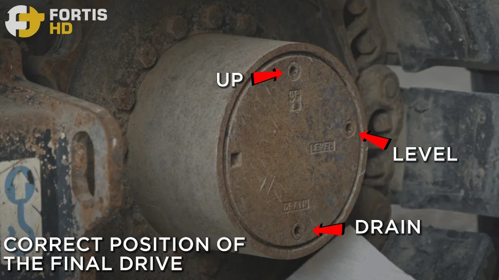 Arrows pointing at the final drive's up, level, and drain plugs on a John Deere 85G Excavator.