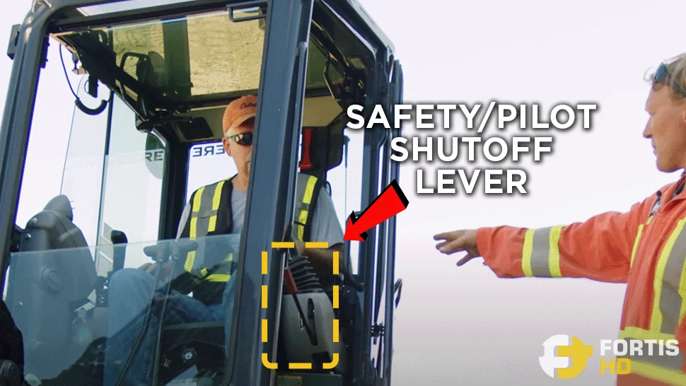 Arrow shows the location of the Pilot Shutoff Lever (Safety Lever) on a John Deere 35G mini excavator.