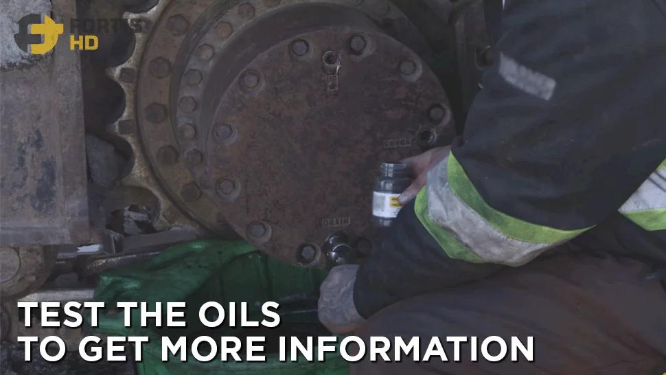 Heavy-duty mechanic gets an oil sample from an excavator’s final drive.