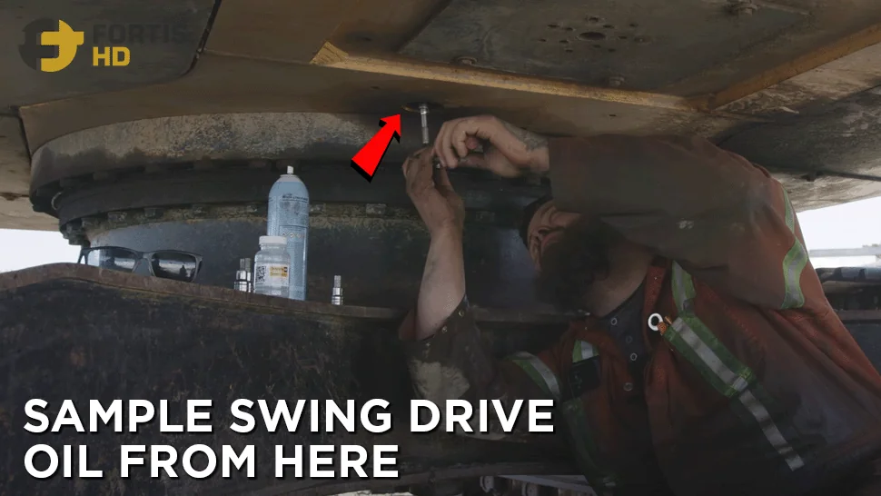 Heavy-duty mechanic removes the drain plug of an excavator’s swing drive.