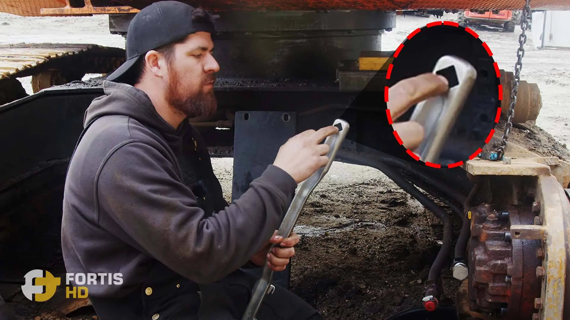 A heavy-duty mechanic shows the square hole for extra leverage of the Mueller Kueps wrench extender.
