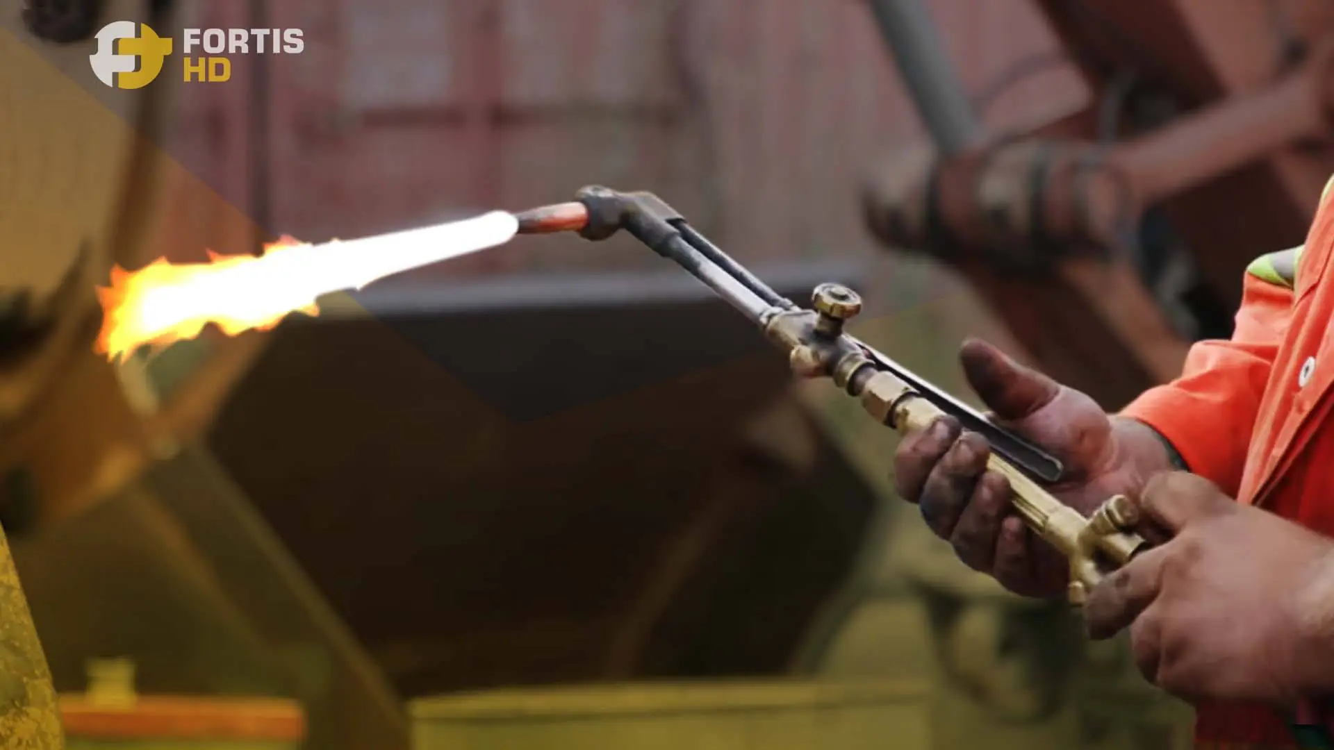 A heavy-duty mechanic uses a blowtorch.